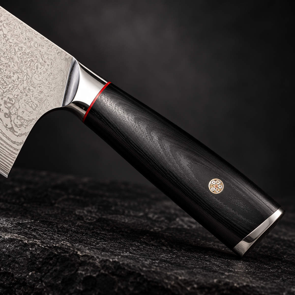 Summit bone chopper handle detail showing the red accent, mosaic pin and polished metal fittings