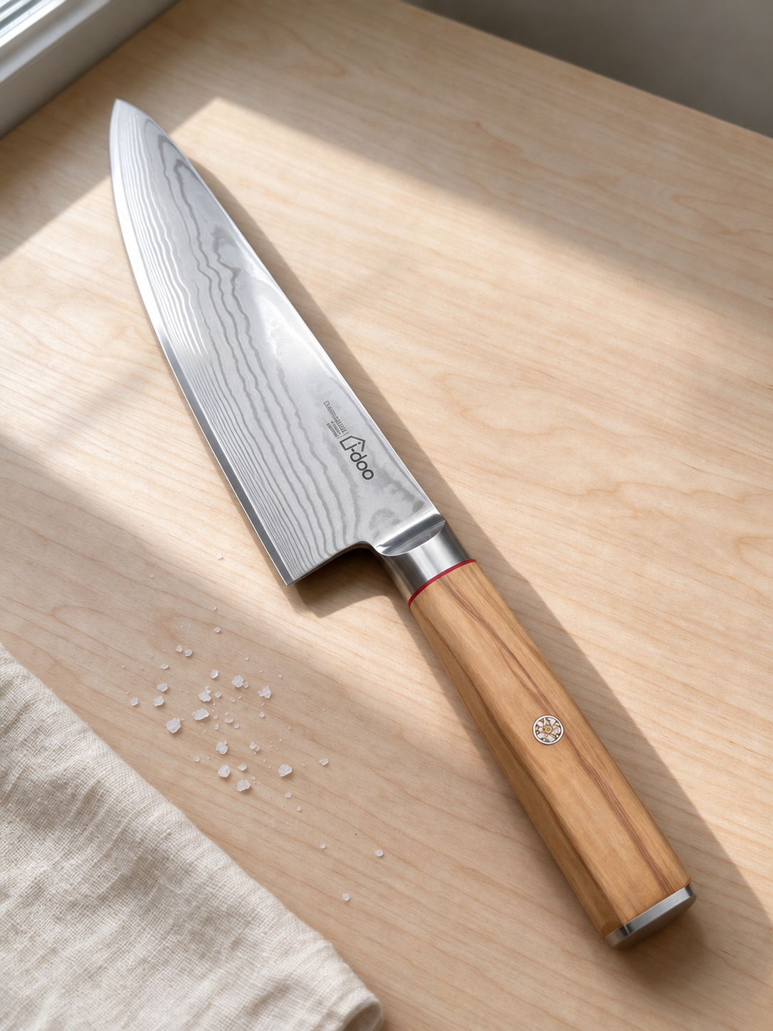 Bondi chef knife with olive wood handle in natural sunlight