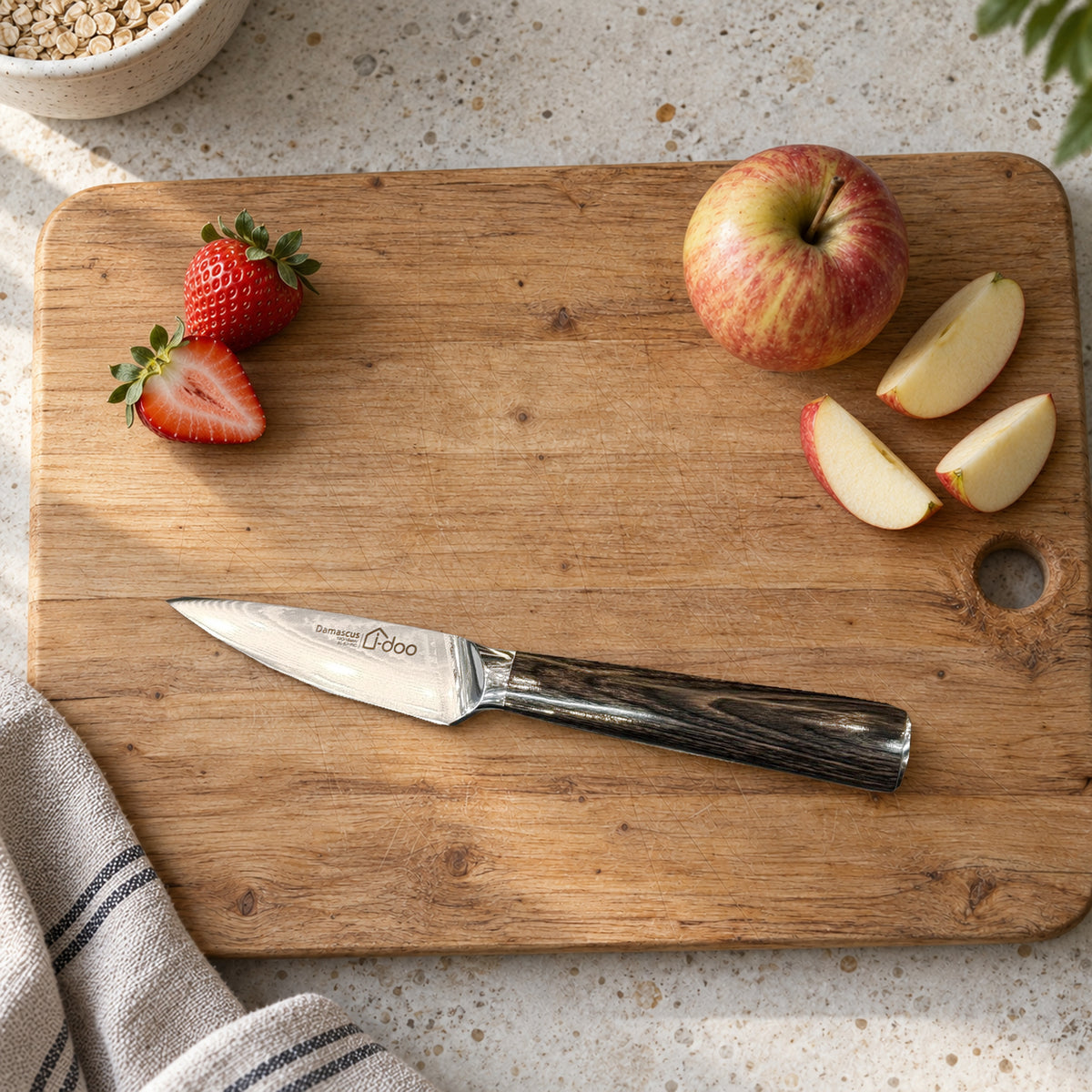 HJ 3.5-inch paring knife beside prepared apple and strawberries on a timber board