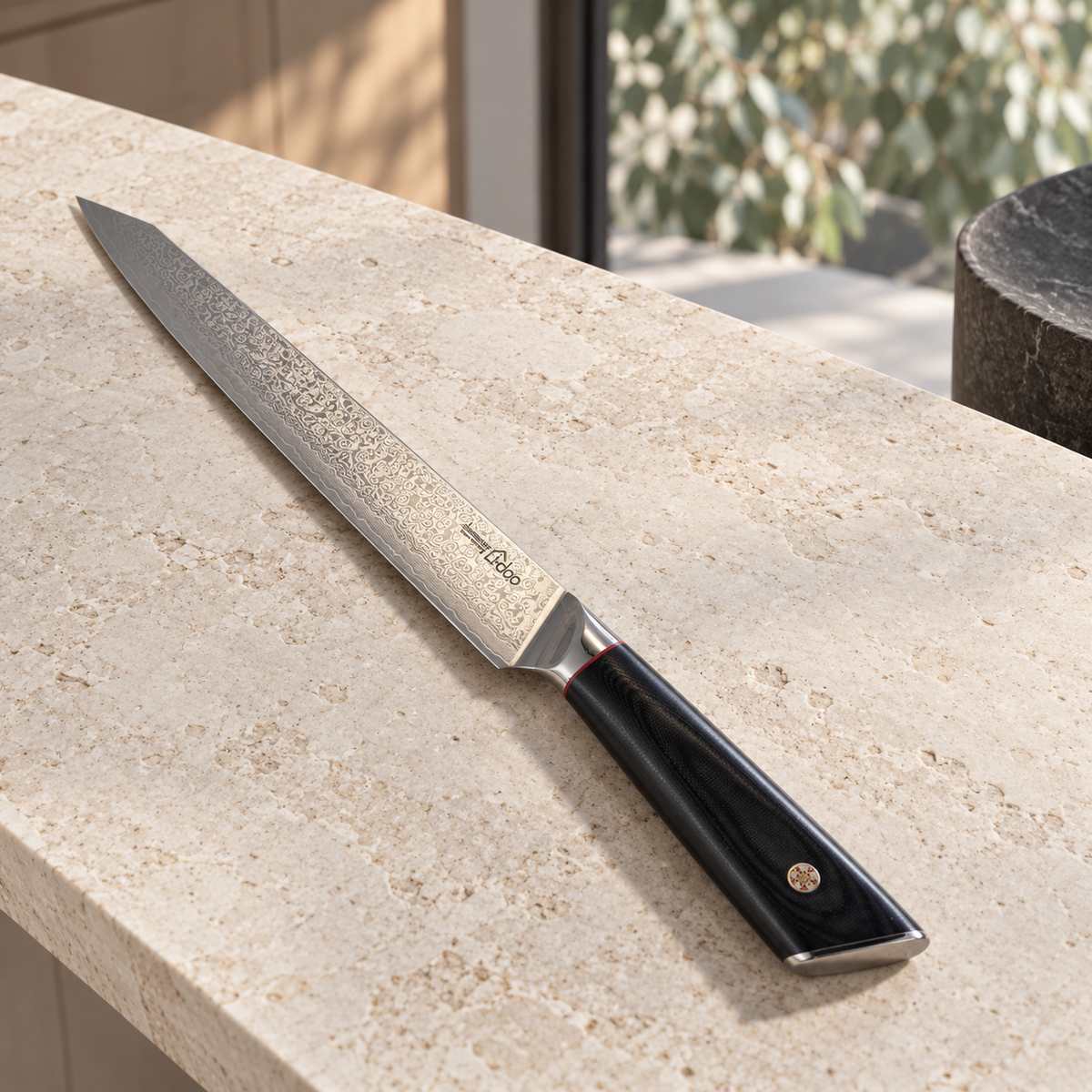 Black handled AUS-10 Damascus slicing knife in a light-filled Australian kitchen
