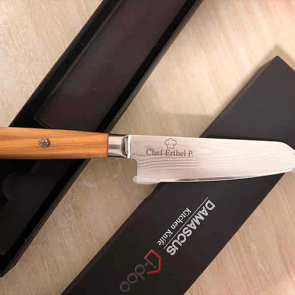 Personalised engraving example on an i-DOO olive wood handle Damascus knife beside its gift box