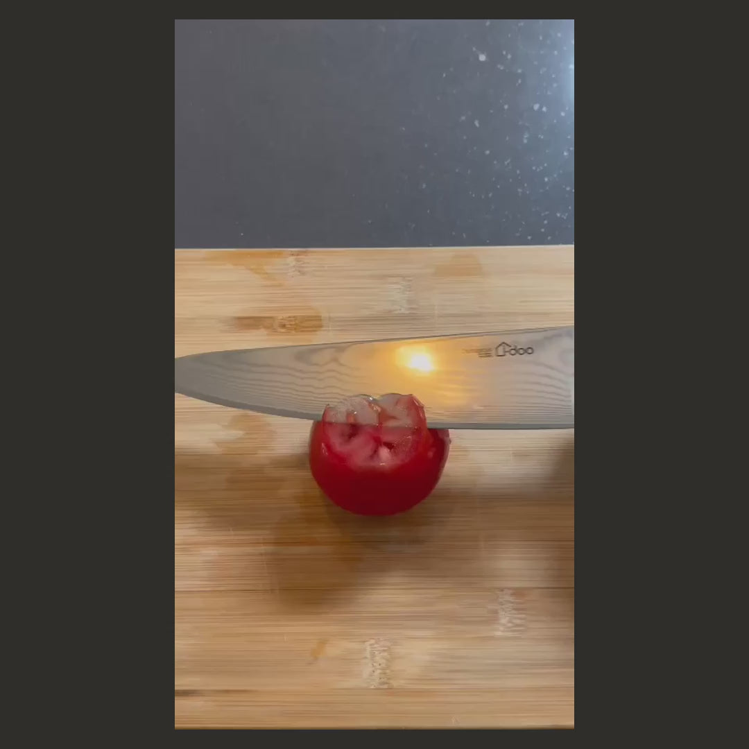 Bondi 8-inch chef knife in use — full original frame, square presentation